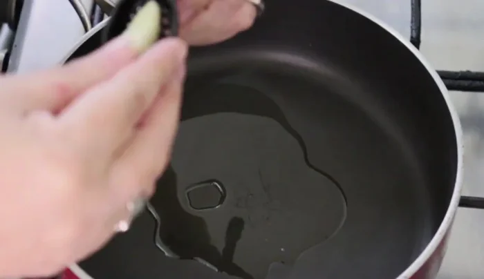 In a saucepan, add a splash of oil, minced garlic, and sauté until fragrant. (52.379)