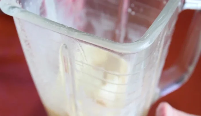 Add the evaporated milk to the blender.