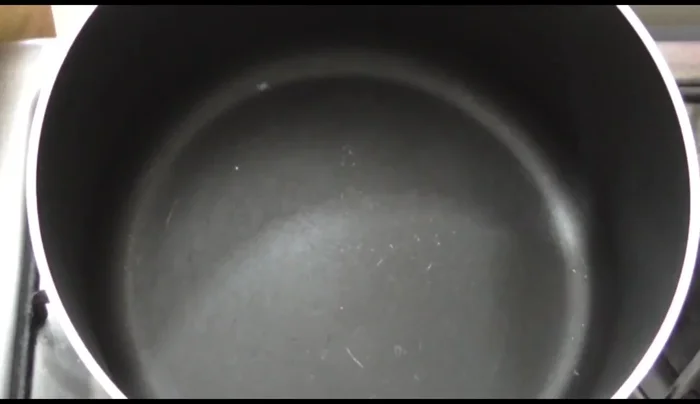 Add the pumpkin pieces to the saucepan, along with 2 cups of water.