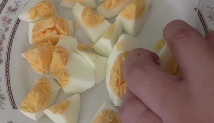 Form small meatballs, incorporating chopped hard-boiled egg into each.