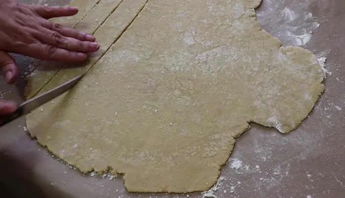 Cut strips from the remaining dough and arrange them on top of the pie in a lattice pattern. Brush with beaten egg and sprinkle with sugar.