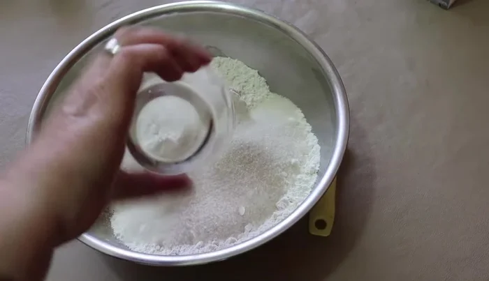 In a bowl, combine butter, flour, sugar, eggs, vanilla, salt, and cold water. Knead until the dough no longer sticks to your hands.