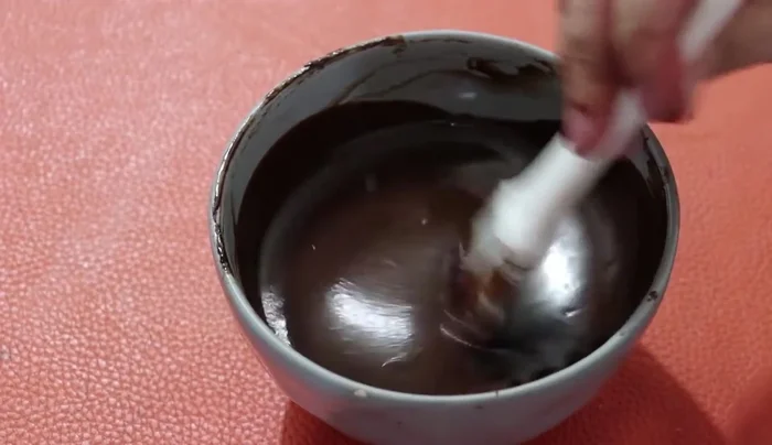 Pour the ganache over the cheesecake layer.