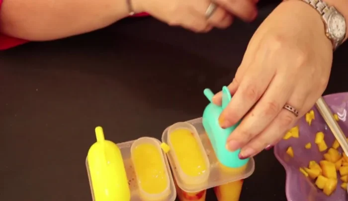 Insert popsicle sticks and freeze for 4-5 hours.