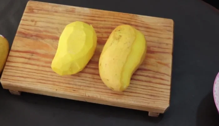 Peel and chop the mangoes into small squares.