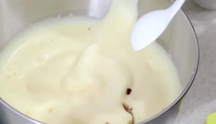 Add vanilla extract and condensed milk (or sugar substitute) to the beaten eggs.