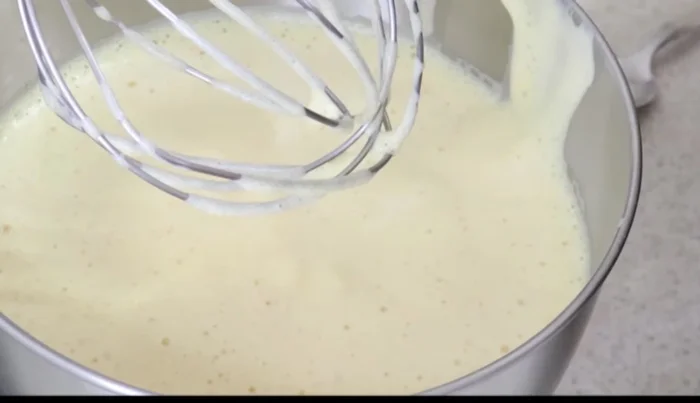 Gradually add the sifted flour mixture to the wet ingredients, mixing at medium speed until a thick batter forms.