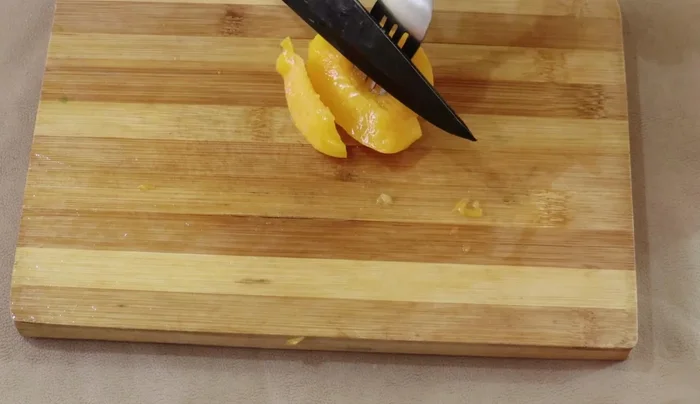 Drain and slice the peaches from the can.