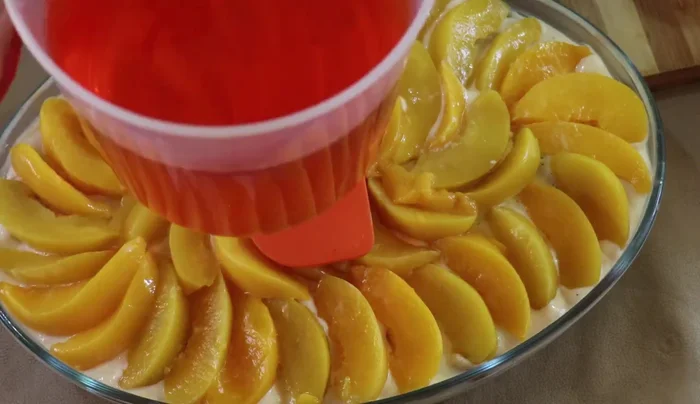 Carefully pour the set peach gelatin over the peaches.