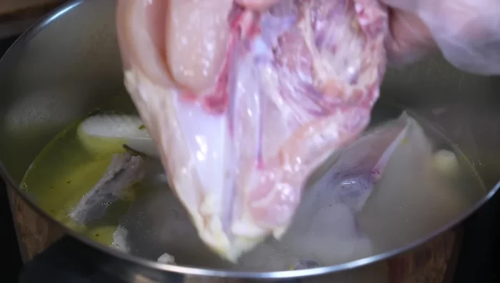 Add chicken breasts: Add chicken breasts to the broth after 25 minutes. Cook for 20 minutes, ensuring they remain juicy and soft.