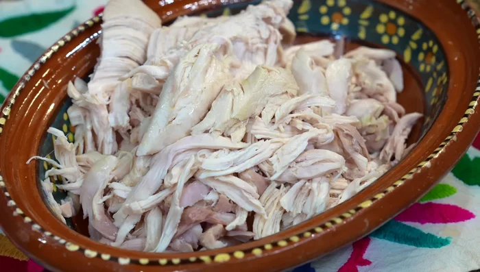 Shred chicken: Once cooked, remove the chicken from the broth, let it cool, remove skin, and shred.
