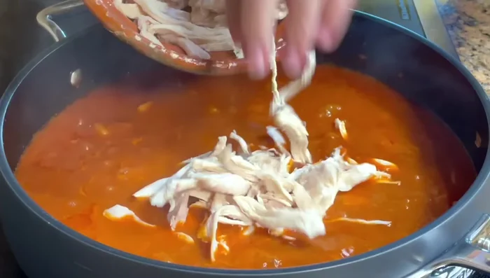 Combine and simmer: Add shredded chicken to the potatoes and sauce. Simmer for a few more minutes to heat through and blend flavors.