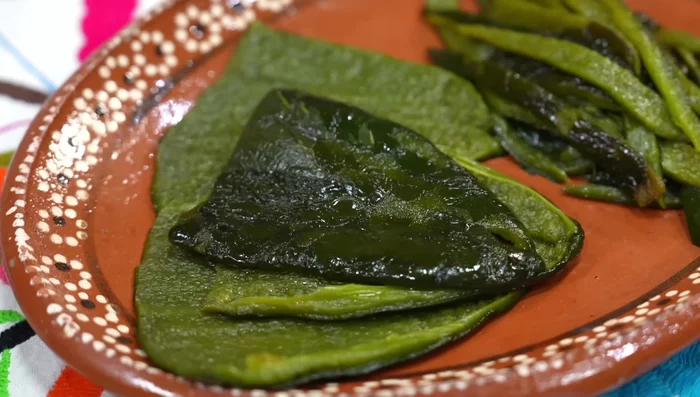Peel and deseed the poblano chilies. Leave two whole, and cut the other two into strips.