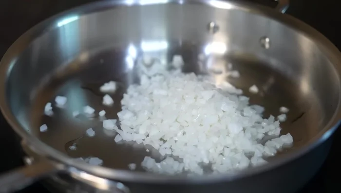 In a saucepan, sauté the chopped onion and corn for 5 minutes over medium-high heat.