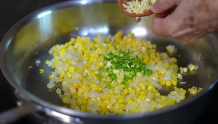 Add the serrano pepper and garlic, and sauté for 1 minute.
