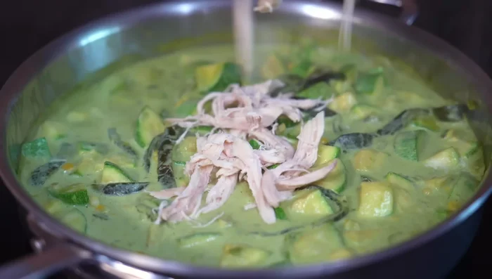 Add the cream and shredded chicken; mix well and cover. Cook for 5 minutes over medium-low heat.
