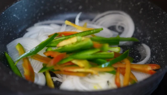Sauté onions and jalapeños in hot oil until onions are half golden (approx. 6-7 minutes). (146.64)