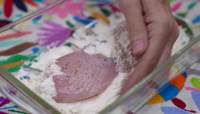 Dredge tilapia fillets in seasoned flour. (230.099)