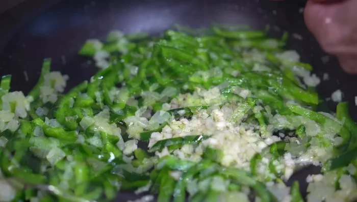 Add garlic and oregano, cook for 1 minute. Add tomatoes, salt or chicken broth powder, and simmer for 5 minutes.