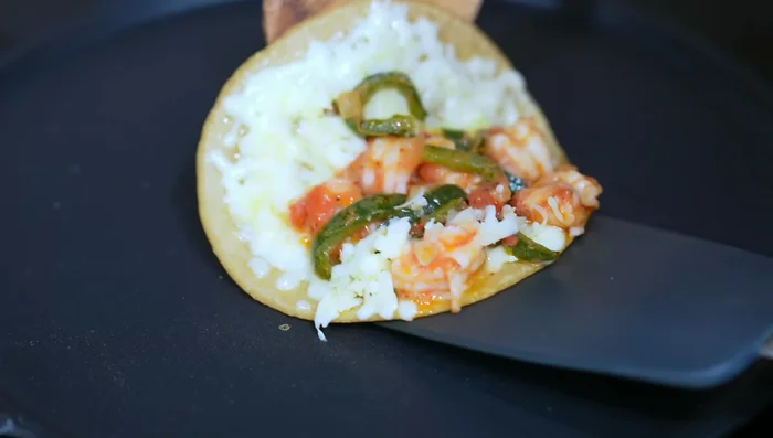 Add shrimp filling to half of the tortilla and fold.