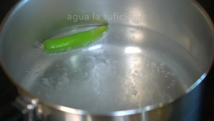 Prepare the sauce: Boil serrano pepper for 5 minutes, then add tomatoes and cook until skins burst. Let cool.