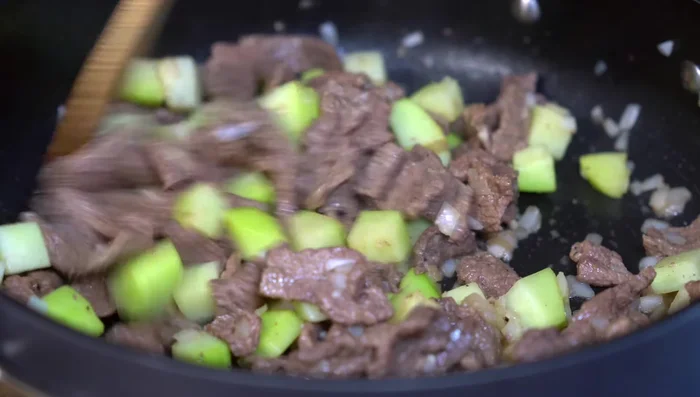Add the prepared tomato sauce, stir, and simmer on medium-low heat, covered for 10 minutes.