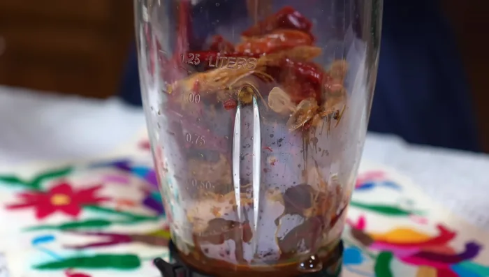 Let the mixture cool, then blend the sautéed ingredients, including the remaining raw garlic clove and water. Strain the mixture.