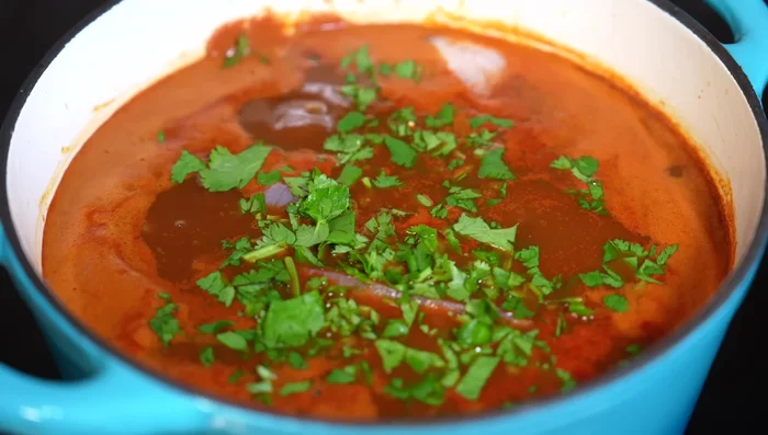 Add the tilapia, cilantro (or epazote), and simmer on low heat until fish and vegetables are cooked through (about 5 more minutes).