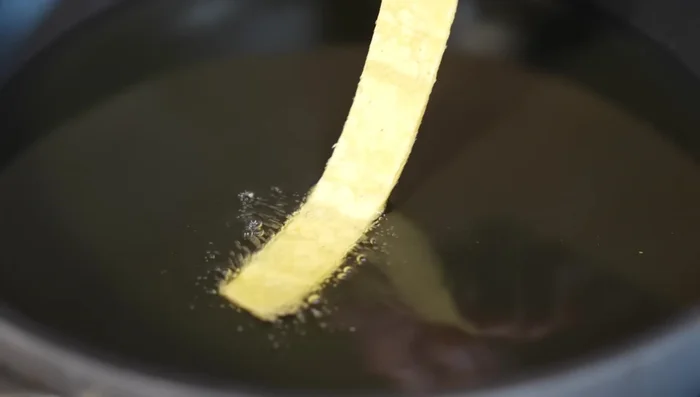 Fry corn tortillas until golden brown.