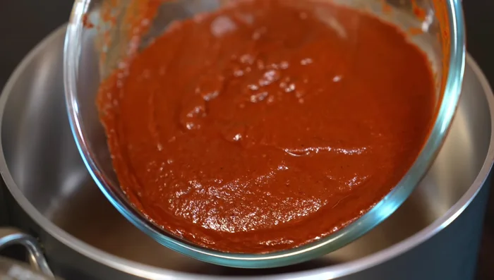 In a saucepan, cook tomato-chili sauce with salt or bouillon powder for 8-10 minutes.