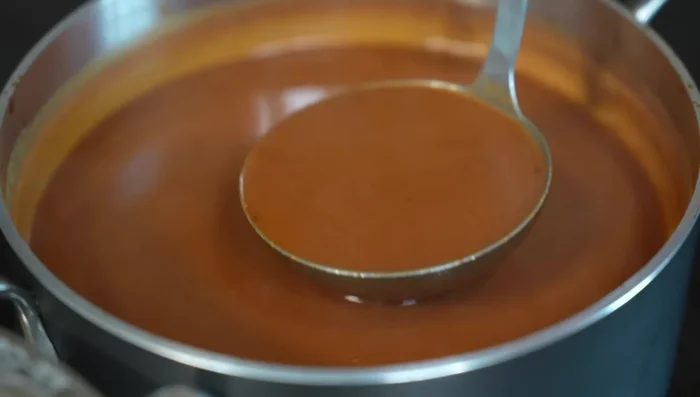 Serve Tarascan soup with cheese, tortilla strips, cream, and fried ancho chili.