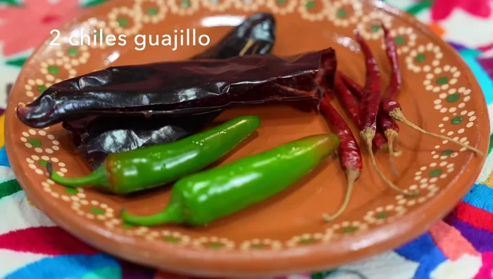 Prepare the ranchera sauce: In a pan, sauté sliced onions, garlic, and halved serrano chilies until slightly golden. This enhances the sauce's depth.
