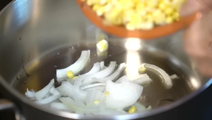 In hot oil, sauté onion and corn kernels. [200.25]