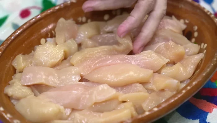 Cut chicken breasts into fajita shapes. Season with salt and pepper. Set aside. [34.09]