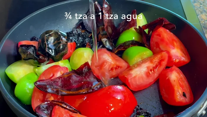 Add water and cover. Cook for 15 minutes over medium heat until chiles are soft. Let cool.
