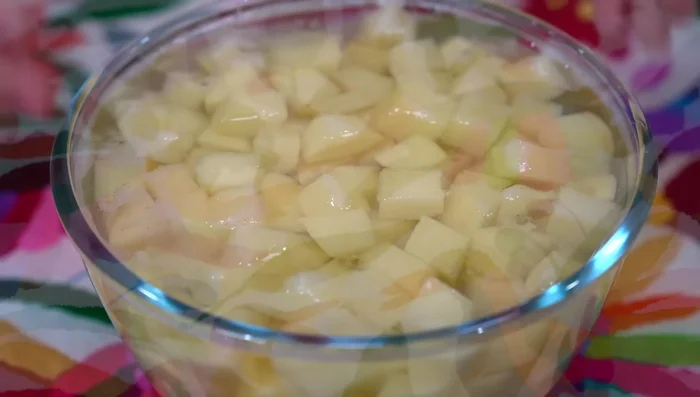 Peel and cube the potatoes and soak in water to prevent discoloration.
