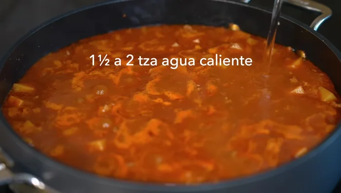 Once the sauce slightly changes color, add more hot water (to avoid lowering the temperature) and cover. Cook for 15 minutes until potatoes are tender.