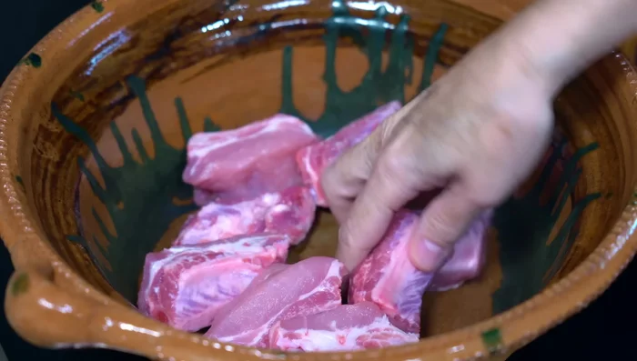 Place ribs in a casserole dish. Add a little water and cook until they release their fat.