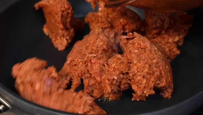 Cook the meat: In a pan with little oil, cook the marinated meat over medium-high heat, stirring constantly, until it breaks apart. Add onion and season with salt if needed.