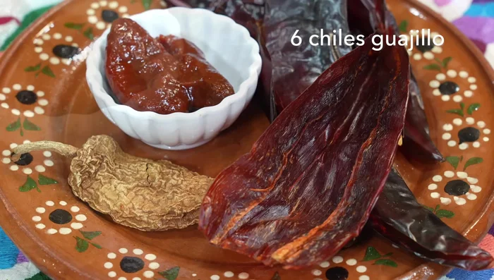 Prepare the adobo: In a frying pan with hot oil, sauté garlic until golden. Add onion, then dried chipotle pepper. Once the oil hydrates the pepper, add guajillo peppers (cut into pieces), bay leaves, water and vinegar. Cover and let it simmer until peppers are soft.