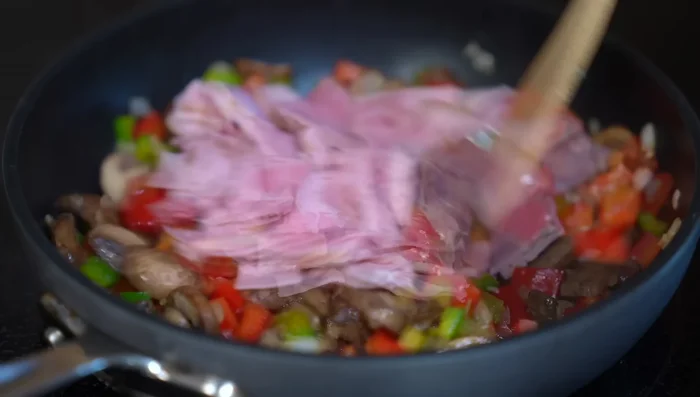 Add ham to the filling and cook for 2-3 minutes until flavor is released.