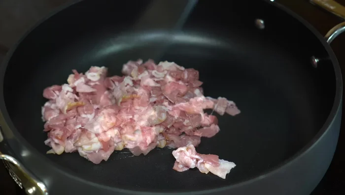 Fry bacon until golden brown. Remove bacon and set aside, reserving the bacon fat.