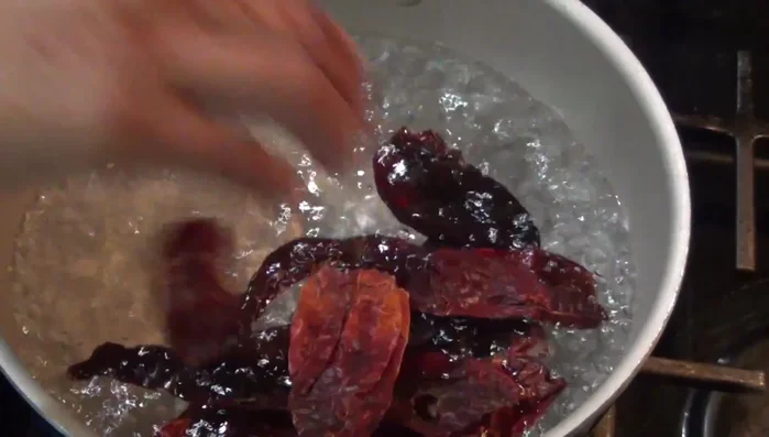 Soften the chilies (Morita, Guajillo/California, Ancho) in boiling water.