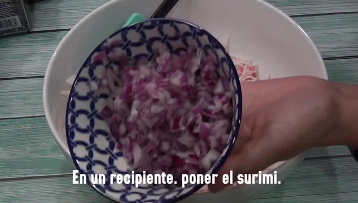 Prepare the ingredients: finely chop the onion, green chilies, tomatoes, cucumber, and cilantro.