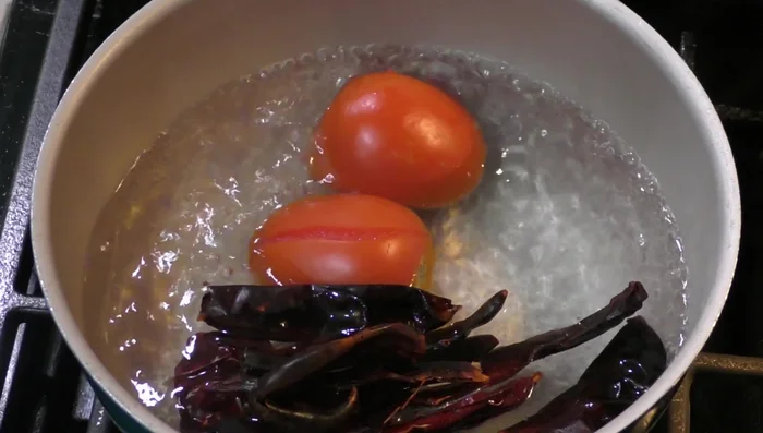 Add the puya, California, guajillo, and tree chilies to the pot.