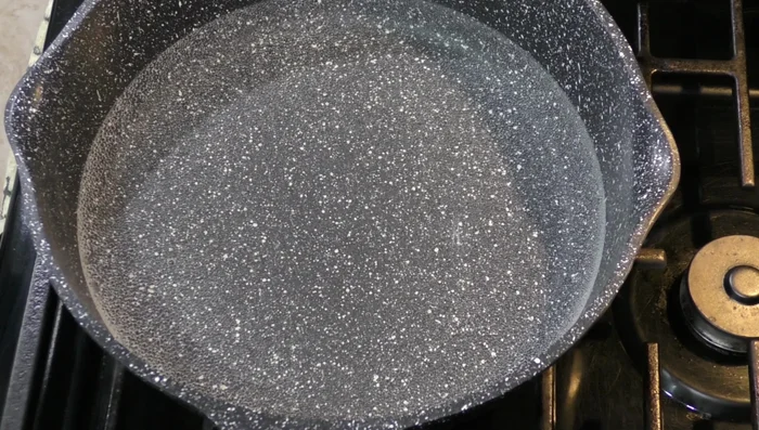 In a saucepan, bring 4 cups of water to a boil. Add the pork and a little salt to taste.