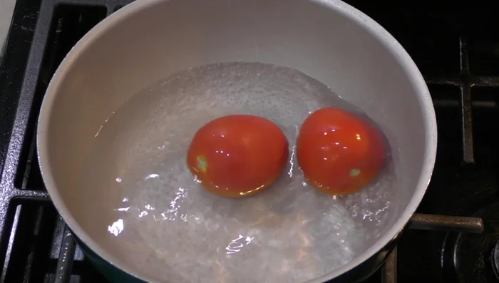 Add the two tomatoes to the pot and let them boil for a few minutes.