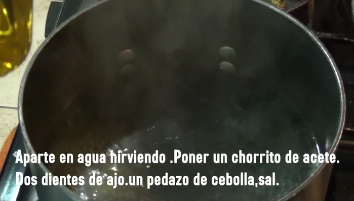 Boil water in a pot. Add a splash of oil, garlic cloves, a piece of onion, and salt (110.92, 121.409). Add the spaghetti and cook until al dente (132.17, 148.64). Drain, reserving some pasta water (162.29).