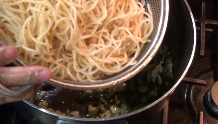 Add the cooked spaghetti to the sauce and stir to combine (318.44). Add salt and cheese to taste. Simmer for a few minutes (400.4, 429.449).