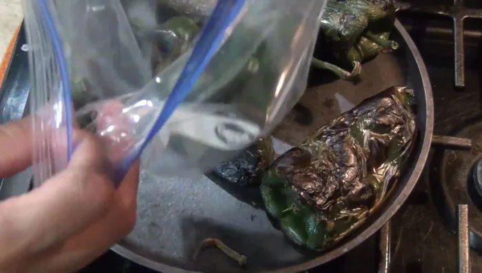 Roast the poblano peppers until well-done on all sides (57.78). Place them in a plastic bag to steam and peel easily (60.55, 66.68). Remove the skin and seeds (74.11, 79.869). Cut two peppers into strips and blend the remaining four (94.759, 98.96).